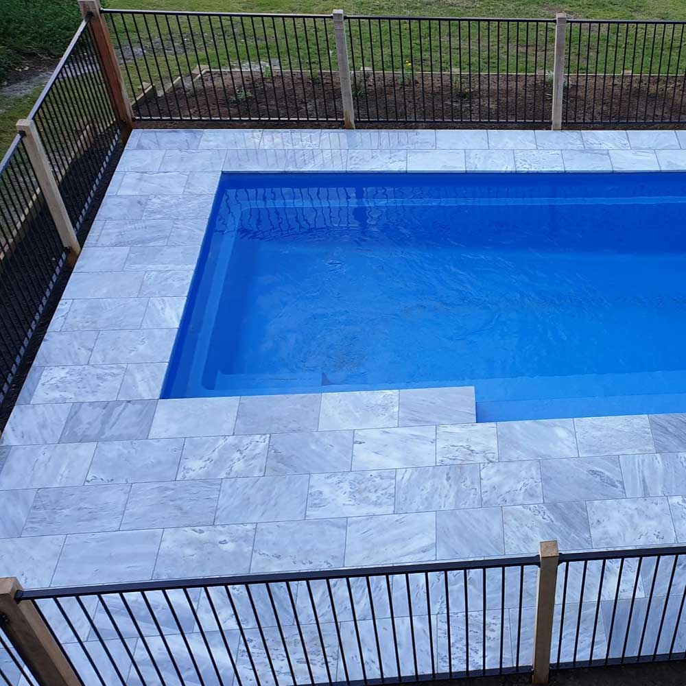 Luce Grey Sandblasted Tumbled Limestone 600x400x30mm Natural Stone Pavers - 1st Quality - Swimming Pool Picture - Available at iPave Natural Stone